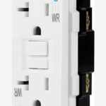 Close-up of a white electrical outlet with a test/reset button and safety features.
